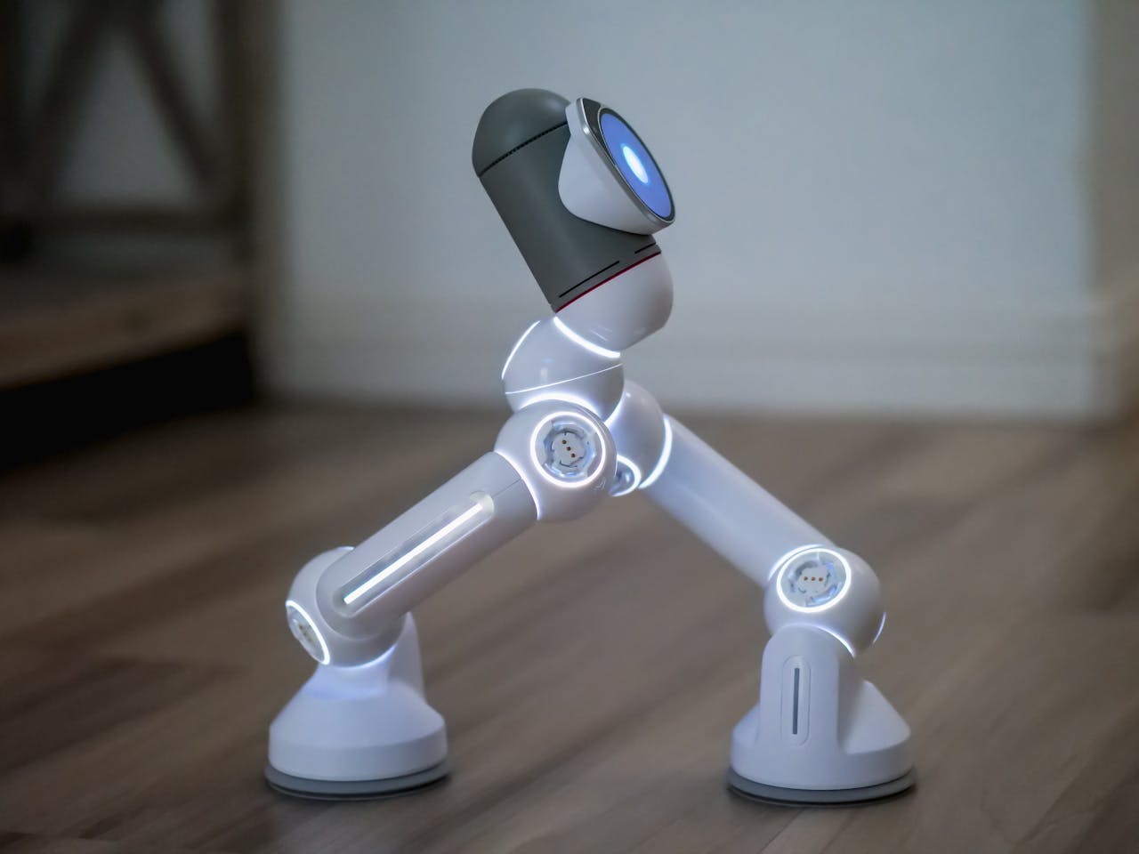 Side view of a modern robot walking on a wooden surface, showcasing advanced technology.